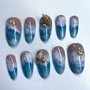 May include: A set of three ceramic mugs with a speckled, matte finish. The mugs are in shades of cream, light gray, and dark gray. Each mug has a simple, minimalist design, perfect for coffee or tea.