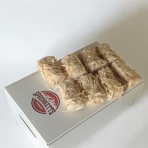 May include: A white box with the "SPRONKETTS OUTDOORS" logo, containing several bundles of natural fire starters. The fire starters are made of a light brown, fibrous material, ideal for outdoor use.