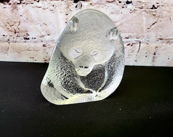 May include: A clear glass sculpture of a panda bear sitting down. The sculpture is made of frosted glass and has a detailed design.