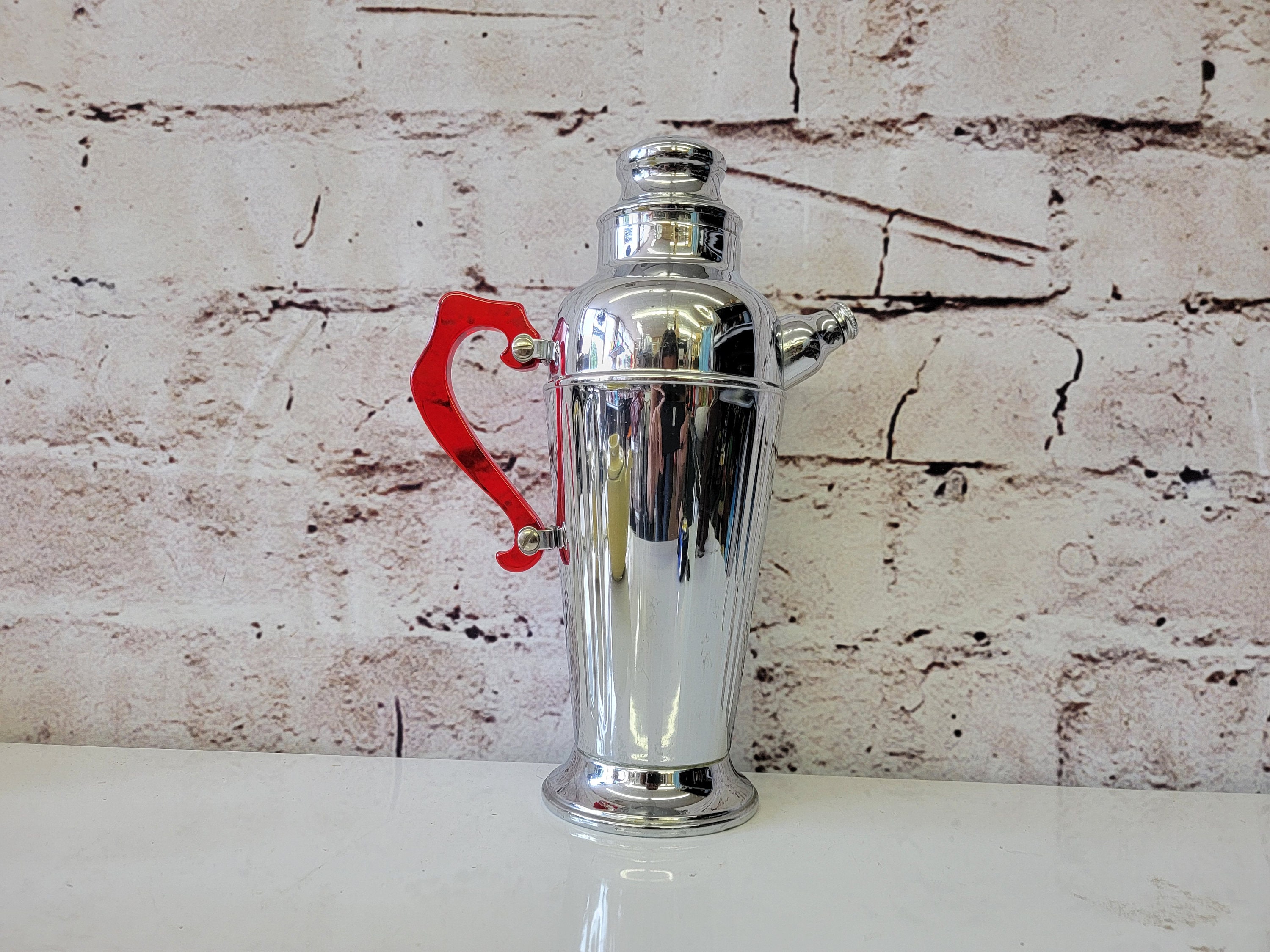Art Deco Chrome Cocktail Shaker With Molded Columns & Red Lucite
