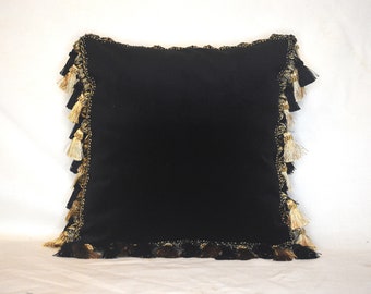 black velvet decorative throw pillow with tassel fringe in black and gold for sofa or bed or chair