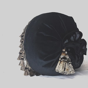 round accent black velvet decorative throw pillow with tassel trim