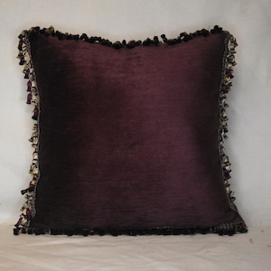 plum purple decorative throw pillow with purple and gold fringe for living room sofa