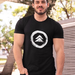May include: A black t-shirt with a white graphic of a stylized arrow in a circle. The arrow is pointing upwards.