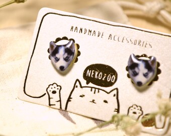 May include: A pair of handmade earrings featuring a white and gray husky dog design. The earrings are displayed on a card with the text "Handmade Accessories" and "Neko Zoo".