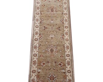 Könnte beinhalten: Ein beiger Läuferteppich mit braunem Blumenmuster. Der Teppich hat einen cremefarbenen Rand mit einem sich wiederholenden Blumendesign.