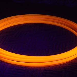 May include: A bright orange glow stick hoop, a popular toy for kids and adults. The hoop is made of flexible plastic and is designed to be safe for play.