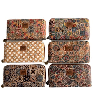 May include: Six rectangular cork wallets arranged in two columns. Each wallet features a unique pattern, including floral, geometric, and tile-inspired designs in various colours. A small brown rectangular brand tag is centred on each wallet.