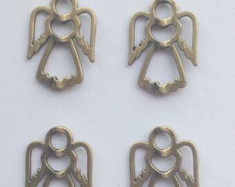 May include: Four gold metal angel charms with a heart in the center. The charms are cut out and have a delicate design.