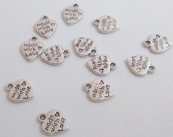 May include: Ten silver heart-shaped charms with the text "Made with Love" on each charm.