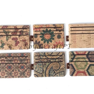 May include: Six different cork card holders with various patterns. The card holders are brown with different colored patterns including butterflies, flowers, paisley, and geometric designs.