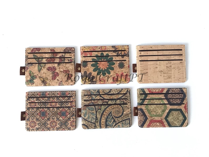 May include: Six different cork card holders with various colorful patterns. The patterns include butterflies, flowers, paisley, geometric designs, and a honeycomb pattern.
