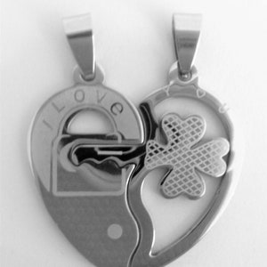 May include: Two silver heart-shaped pendants that fit together. One pendant has the words "I LOVE" and a padlock design. The other pendant has a four-leaf clover design.