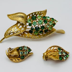Lisner  vintage brooch and clip on earring set . Vintage gold tone and green rhinestones
