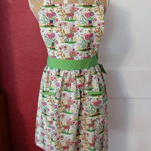 LADIES SPRING APRON  -- Flowers in garden boot, wheel barrel, green polka dot waistband --  2 lined pockets and lined bib --