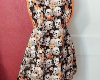 LADIES HALLOWEEN APRON   --   Skulls, orange mums, etc. on black with sweetheart neckline all trimmed in orange