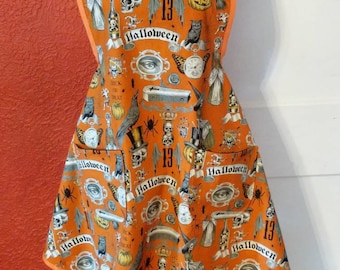 LADIES HALLOWEEN APRON --  burnt orange with Halloween spooky items -- 2 lined pockets, all trimmed in burnt orange