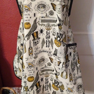 LADIES HALLOWEEN APRON --  2 lined pockets, sweetheart neckline with lace trim, all trimmed in Black