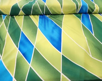 May include: Green, blue, and yellow fabric with a geometric diamond pattern.