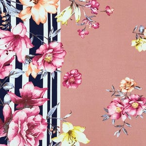May include: A pink and white striped fabric with a floral pattern. The fabric features pink, white, and yellow flowers on a navy blue background.