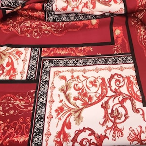 May include: Red, white, and gold fabric with a baroque pattern. The fabric features a repeating design of ornate floral motifs and chain links.