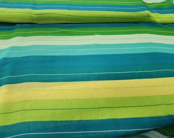 May include: Striped fabric in shades of green, blue, and yellow. The fabric has a sheer, lightweight texture.