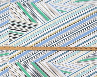 May include: White fabric with a geometric pattern of diagonal stripes in shades of blue, green, and black.
