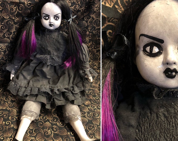 creepy girl with black hair and doll