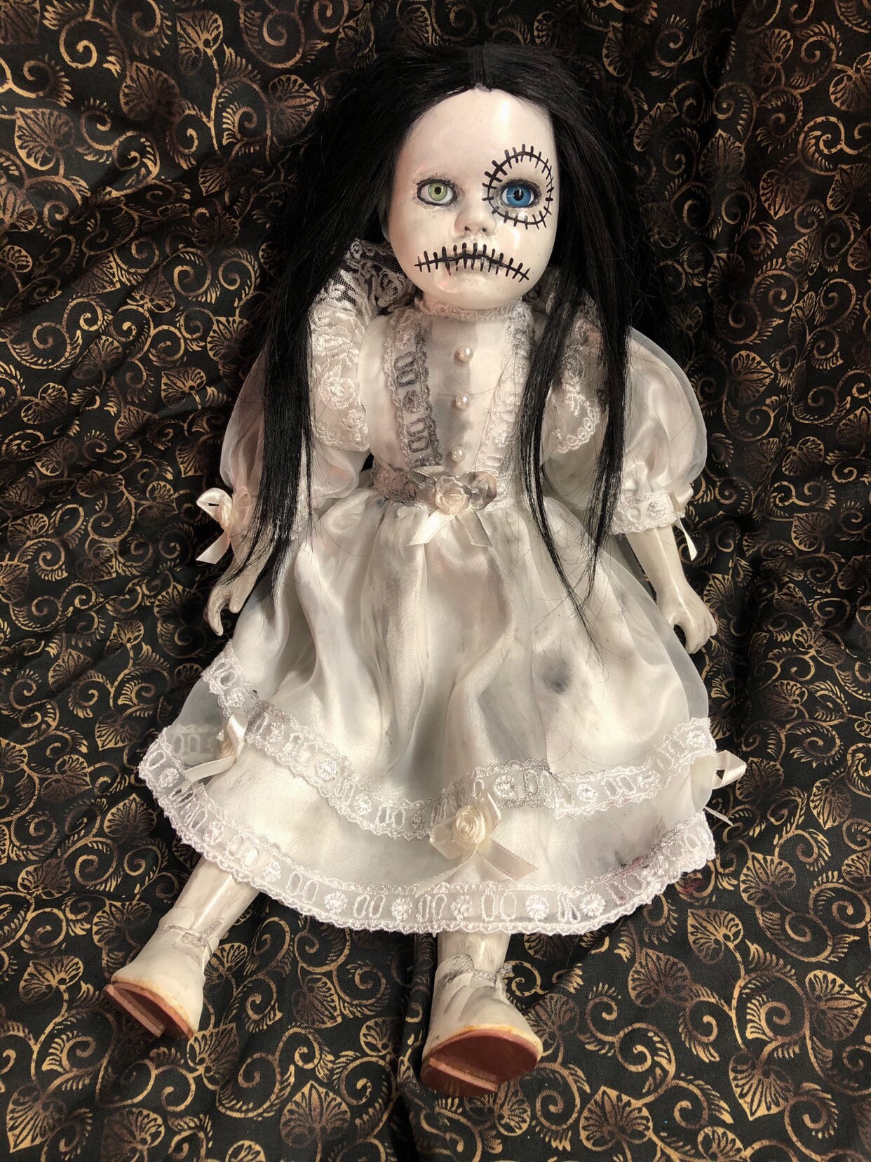 creepy girl with black hair and doll