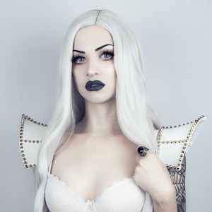 White gothic punk shoulder pads decorated with gold spikes