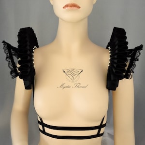 Black lace suspender shoulder pads decorated with black elizabethan ruffs and white Preciosa beads