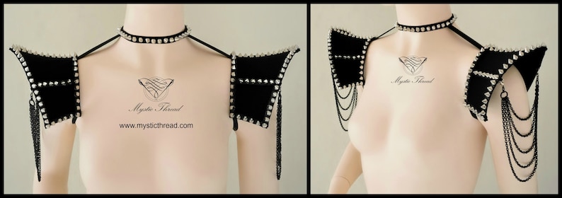 May include: A pair of black velvet shoulder pads with silver studs and chains. The shoulder pads are worn on a mannequin with a silver choker necklace.