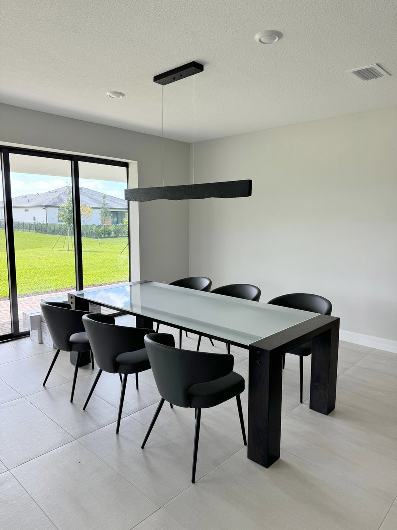 Side view of the linear pendant light made from solid wood, featuring clean geometric lines and a natural oak tone.