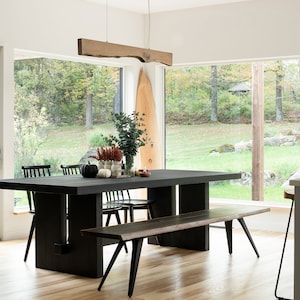 Modern Japandi interior featuring a wooden linear pendant light, natural textures, neutral tones, and clean Scandinavian-Japanese fusion design.