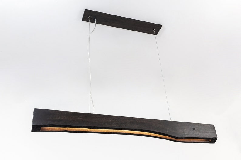Underside view of the wooden linear pendant light with integrated LED lamps. Functional and minimalist with precise craftsmanship