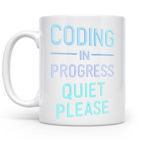 May include: White ceramic mug with the text "CODING IN PROGRESS QUIET PLEASE" in blue and turquoise lettering. The mug has a curved handle and is designed for hot beverages. Ideal for programmers and coders.