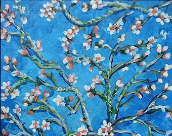 May include: A framed painting depicting a white flowering tree with pink accents against a blue background. The painting is in a style reminiscent of Vincent van Gogh.