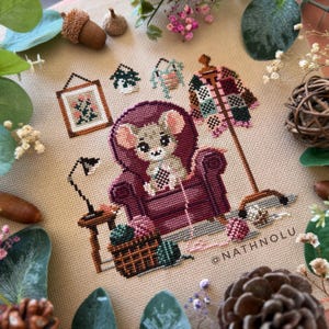 Mouse cross stitch chart showing a cozy armchair craft corner with crocheting supplies and cottagecore decor