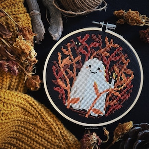 Halloween-themed cross stitch with a delightful yet eerie design