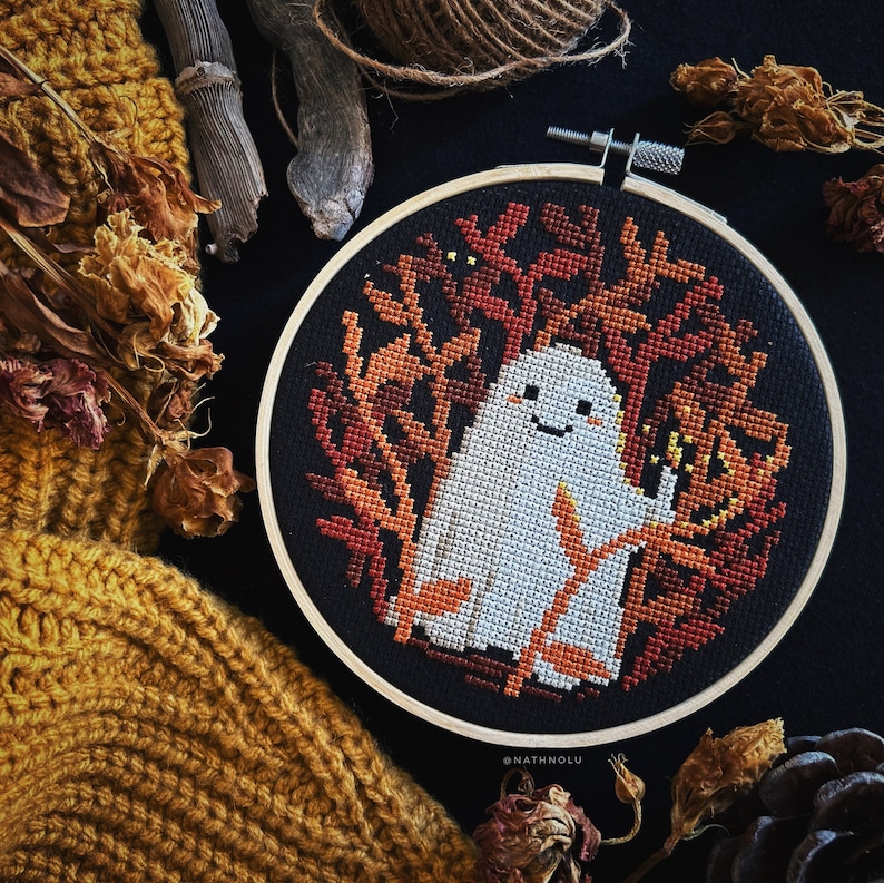 Halloween-themed cross stitch with a delightful yet eerie design