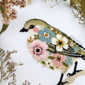 Floral cross stitch pattern of a sweet songbird, blending nature-inspired embroidery with cozy farmhouse decor