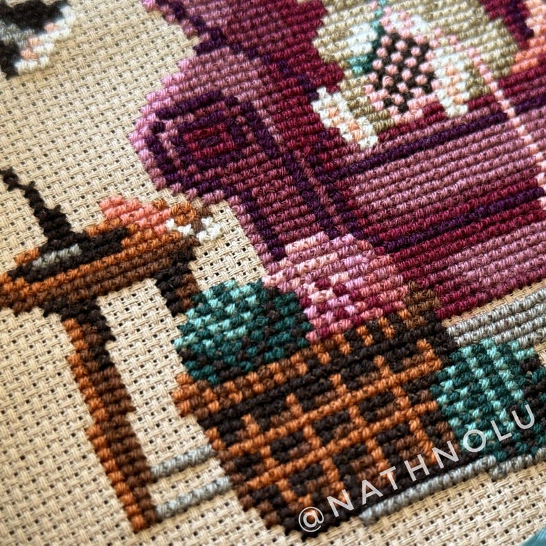Woodland cross stitch pattern featuring a charming crafter mouse surrounded by crochet projects and yarn skeins