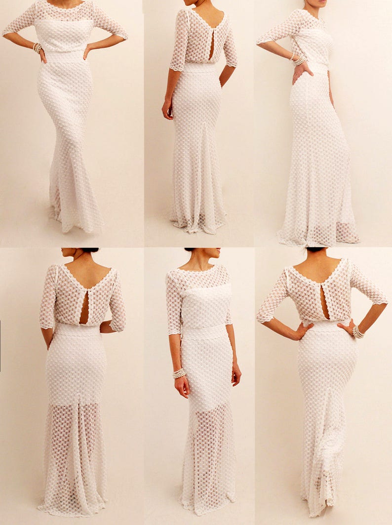 May include: A white, textured, floor-length gown with a fitted bodice and a flared skirt. The dress features a boat neckline, three-quarter sleeves, and a keyhole back. The fabric has a subtle, dotted pattern, and the dress is shown from multiple angles.