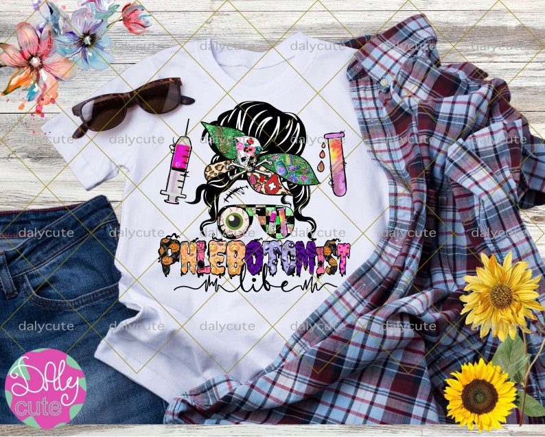 May include: A white t-shirt featuring a graphic of a person with a messy bun, wearing glasses with one eyeball and one patterned lens. The design includes a syringe, a test tube, and the text PHLEBOTOMIST LIFE in colorful, patterned letters.