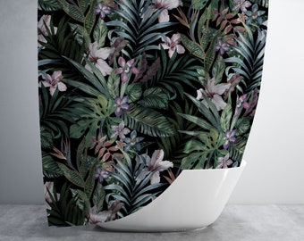 May include: A shower curtain with a lush, tropical botanical print. The design features a dark background with detailed illustrations of large green leaves, white hibiscus flowers, and accents of purple and pink.