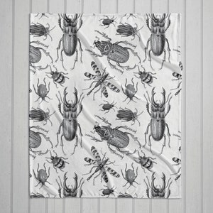 Black and white vintage bugs plush throw blanket with white back