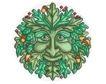 Puede incluir: Un diseño de punto de cruz del rostro del Hombre Verde, un símbolo de renacimiento y naturaleza. La cara es verde con detalles, rodeada de hojas verdes, bellotas y bayas rojas, todo sobre un fondo blanco.