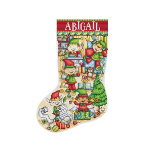 May include: A white Christmas stocking with a red cuff and the name "ABIGAIL" embroidered on it. The stocking is filled with elves wrapping presents, a Christmas tree, and ornaments.