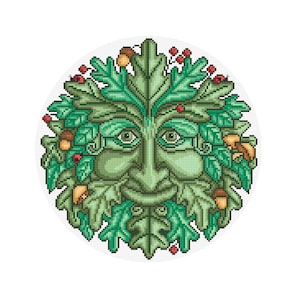 May include: A cross-stitch design of a Green Man face, a symbol of rebirth and nature. The face is green with detailed features, surrounded by green leaves, acorns, and red berries, all set against a white background.