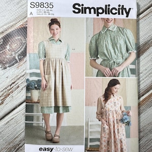 May include: Simplicity sewing pattern S9835, featuring three dress designs. The pattern includes sizes XS-XL. The cover shows images of the finished dresses, with the words "easy-to-sew" and "Designed and printed in USA".